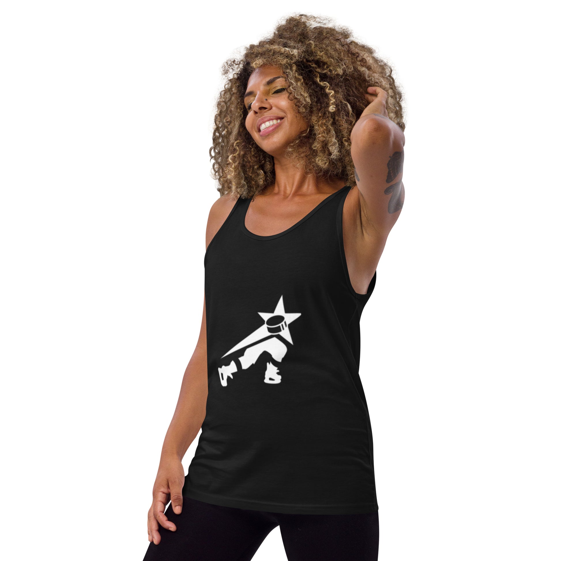 Radiant woman with curly hair smiling, wearing a black tank top featuring a white graphic of a stylized character with a star head and dynamic pose.